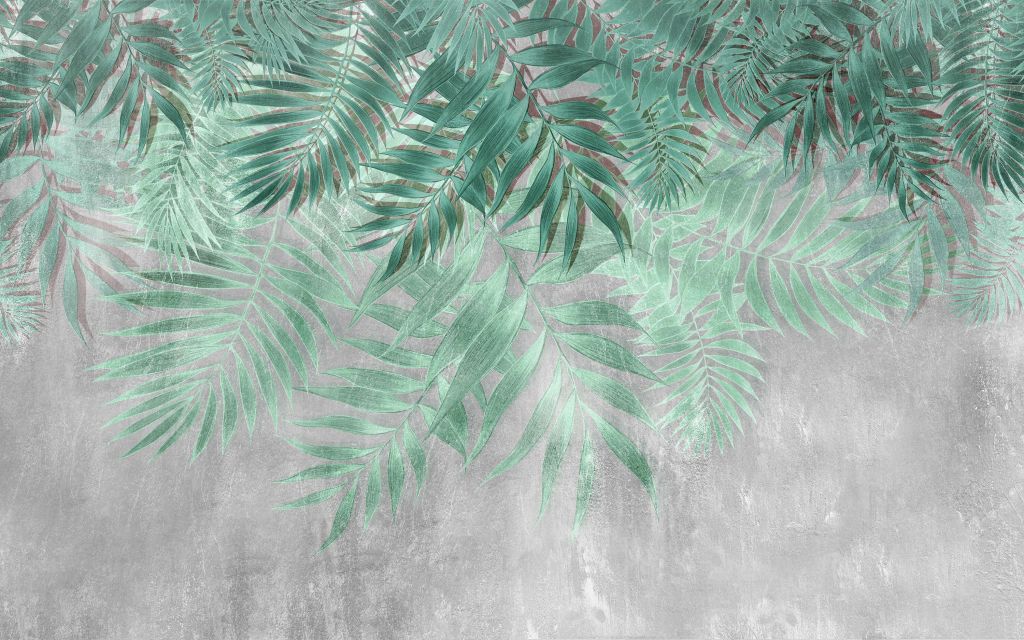 Feuilles de palmier vertes sur un mur en béton gris