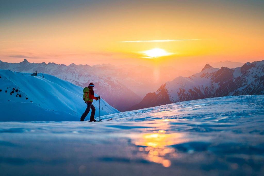 Marche à travers le soleil de montagne enneigée.