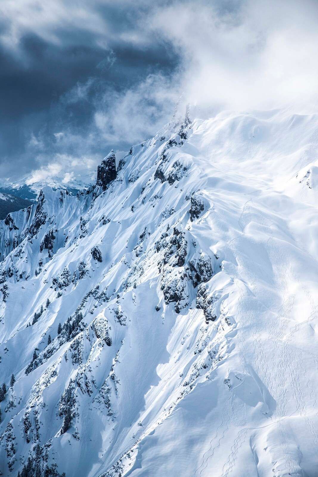 Crêtes de neige sous des nuages ​​orageux